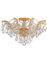 Maria Theresa Semi Flush Mount Draped in Clear Hand Cut Crystal in Polished Gold.
